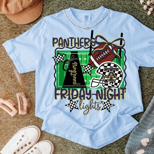 White Comfort Colors t-shirt with Panthers Friday Night Lights graphic featuring football helmet, cheer megaphone, field, and checkered accents.